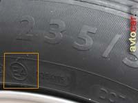 фото боковой поверхности шины в месте нанесения маркировки e1